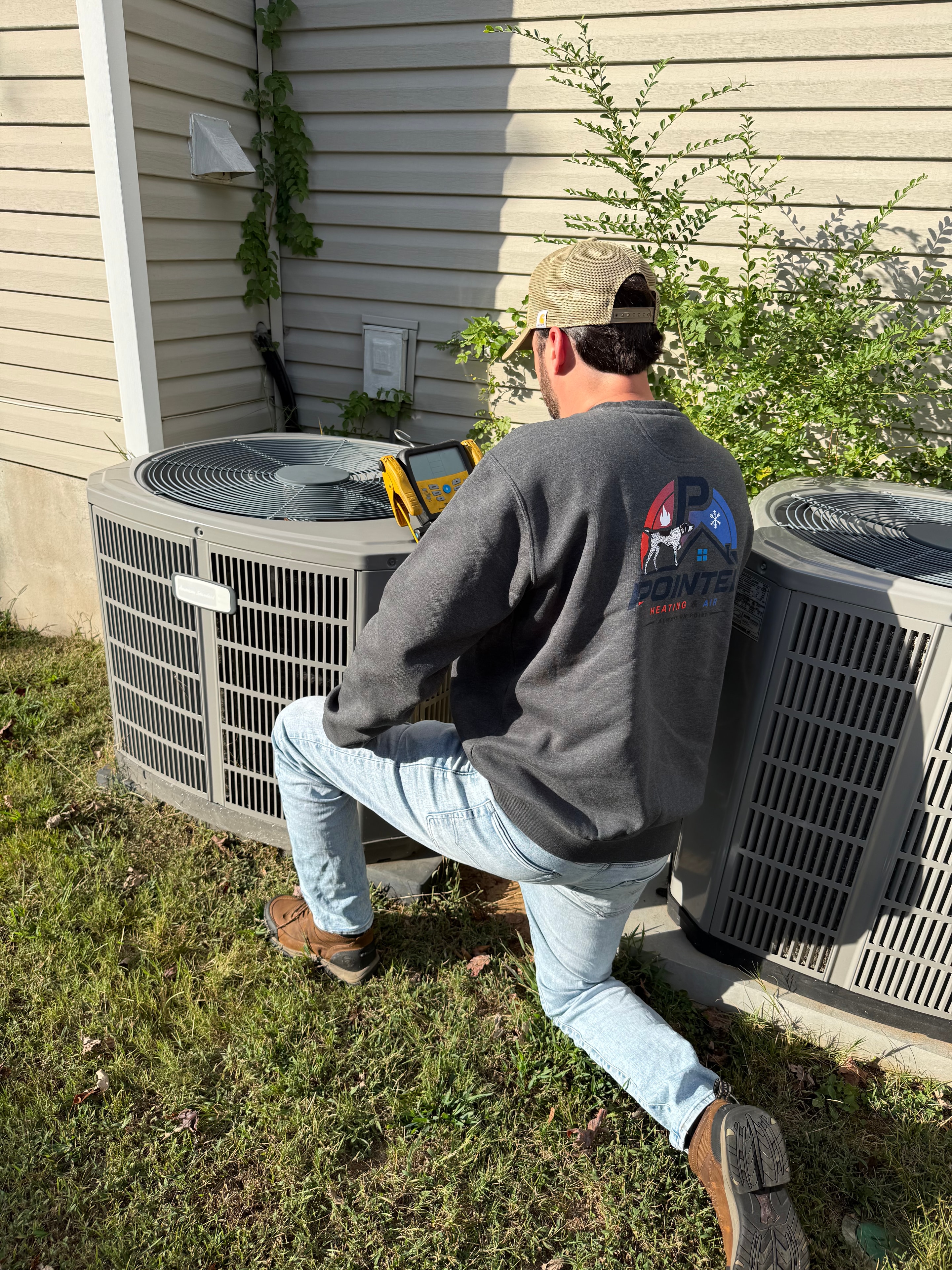 Clint Rise checking an air filter during an HVAC maintenance visit in North Alabama