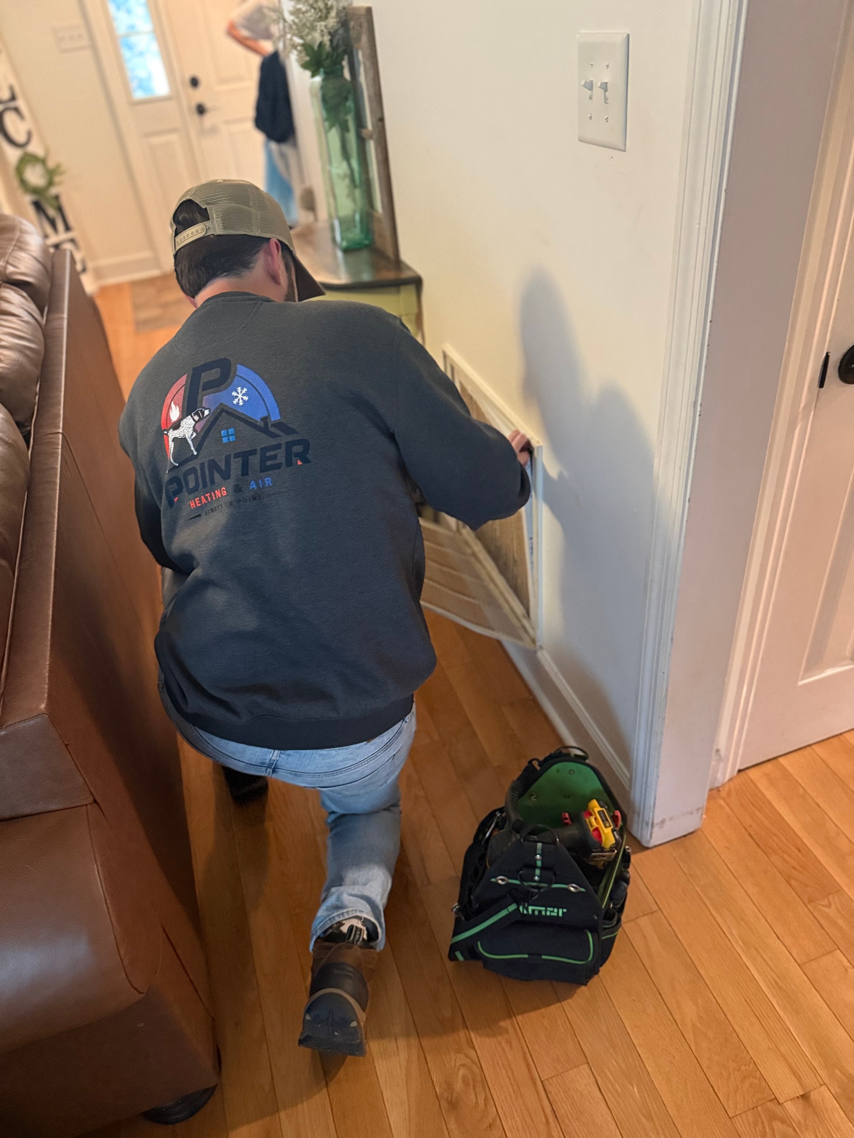 Clint Rise servicing two outdoor HVAC units at a North Alabama home